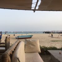 A view from a table and chairs on the beach front